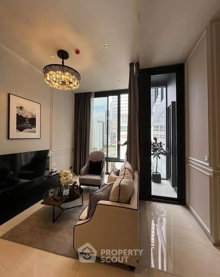 Luxurious modern living room with elegant chandelier and city view balcony.