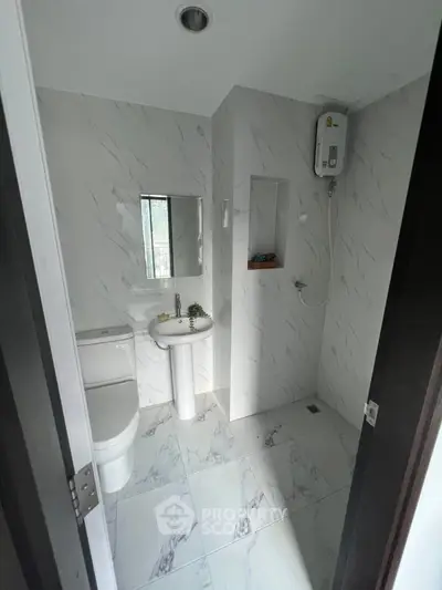 Modern bathroom with sleek marble tiles and compact design