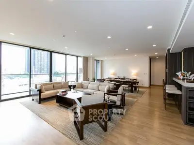 Spacious modern living room with large windows and elegant furnishings