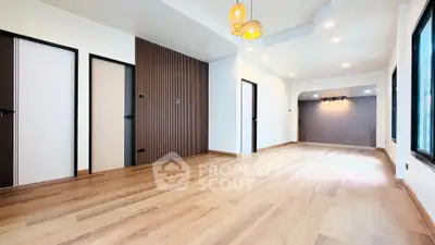 Spacious modern living room with wooden flooring and stylish lighting