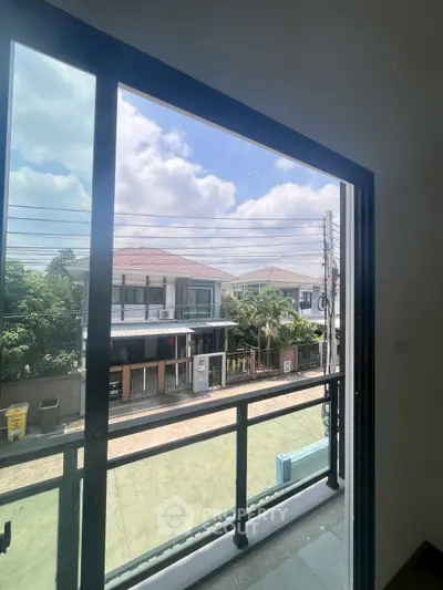 Spacious balcony view overlooking suburban neighborhood with clear skies and modern houses.
