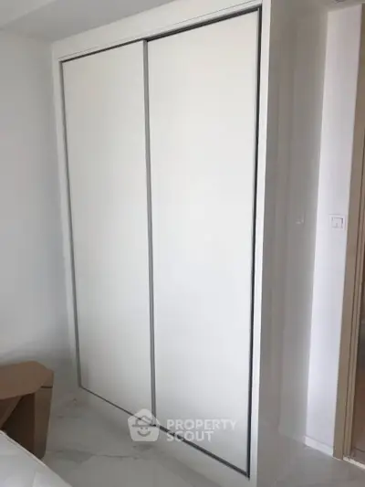 Modern bedroom with sleek built-in wardrobe and minimalist design