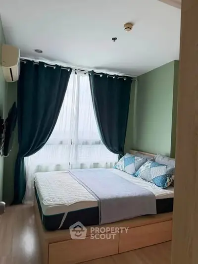 Cozy bedroom with modern decor and large window for natural light