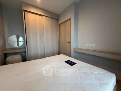 Modern bedroom with built-in wardrobe and cozy decor in a stylish apartment.