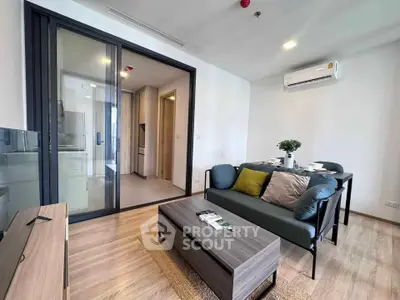 Modern living room with stylish furniture and open kitchen layout in a contemporary apartment.