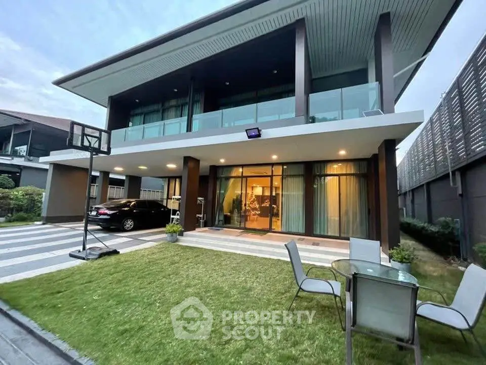 Modern two-story house with spacious lawn and glass balcony