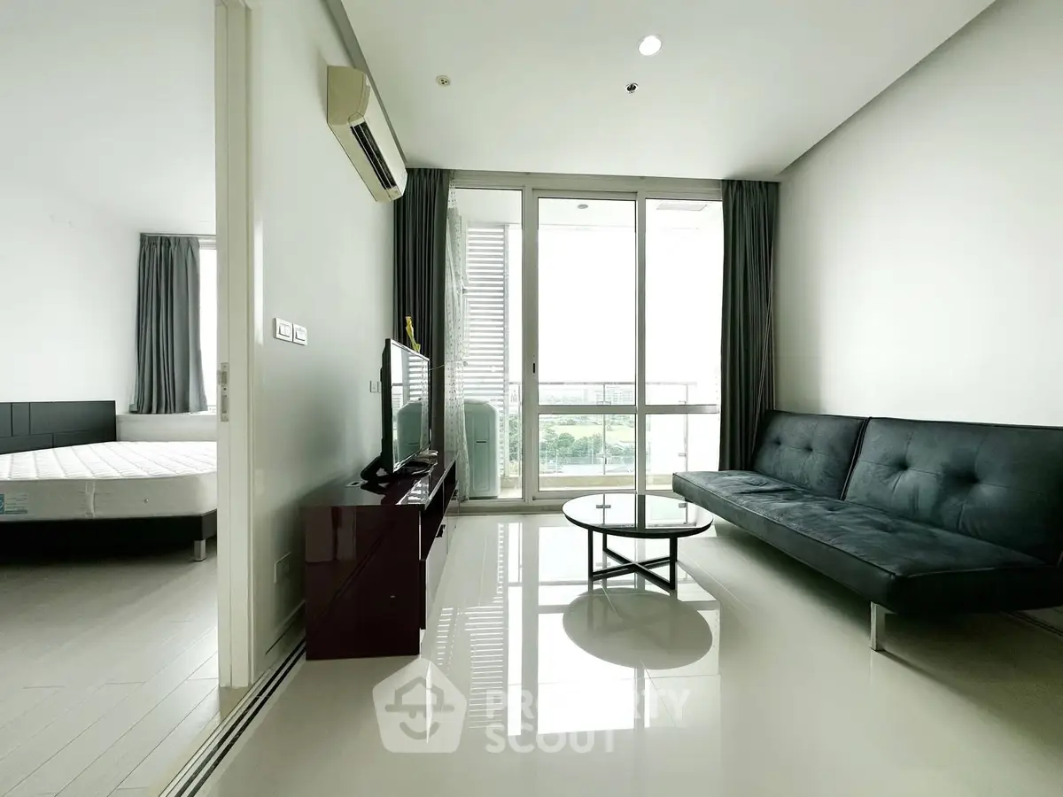 Modern living room with sleek furniture and large windows offering a stunning view.