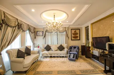 Luxurious living room with elegant chandelier and plush sofas in a sophisticated setting.