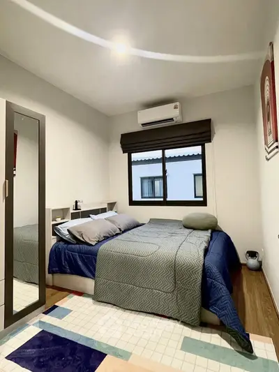 Cozy bedroom with modern decor and ample natural light