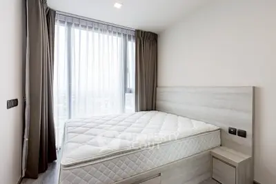 Modern bedroom with large window and stylish decor