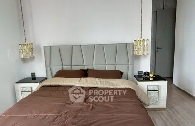 Luxurious bedroom with elegant decor and modern furnishings, featuring a stylish bed and chic lighting.