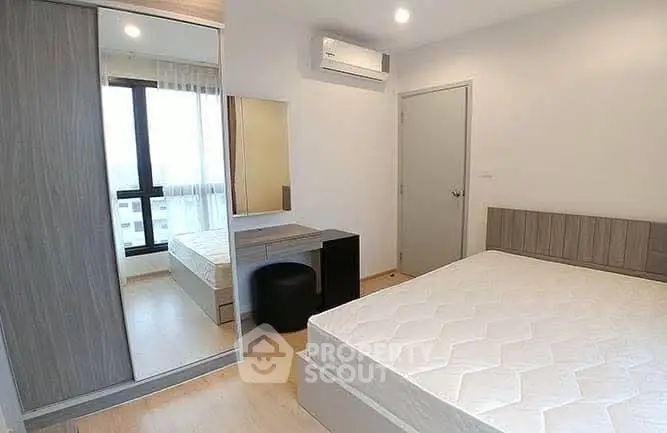 Modern bedroom with large window and sleek furniture design.