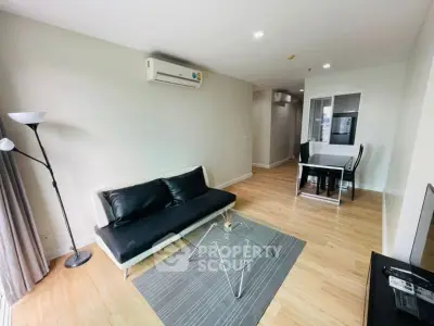 Modern living room with sleek furniture and open layout, featuring a cozy dining area and stylish decor.