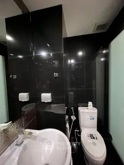 Modern bathroom with sleek black tiles and contemporary fixtures