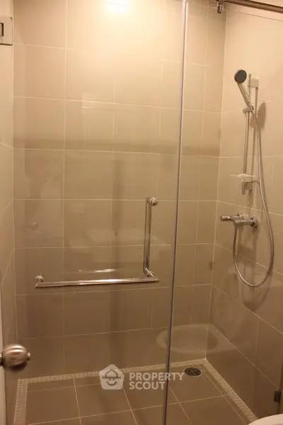 Modern bathroom with glass shower enclosure and sleek fixtures