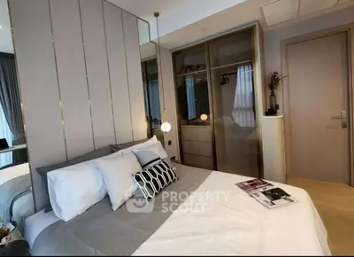 Modern bedroom with stylish decor and mirrored closet doors