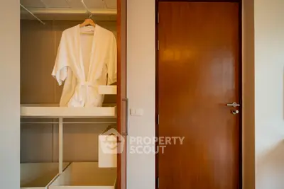 Spacious wardrobe with robe in modern bedroom