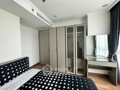 Modern bedroom with stylish decor and ample storage space