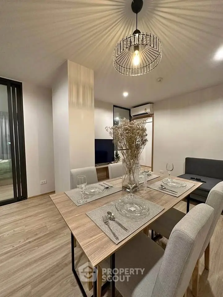 Modern dining area with elegant lighting and stylish decor in a contemporary apartment.
