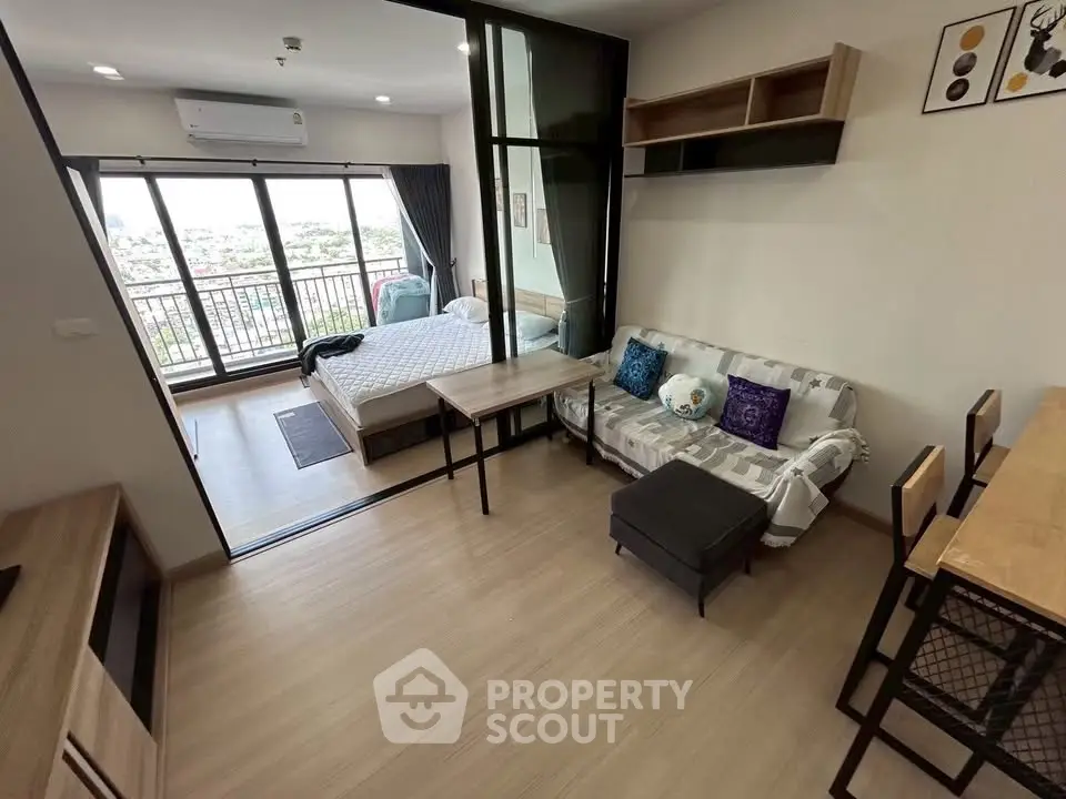 Modern studio apartment with open layout and balcony view
