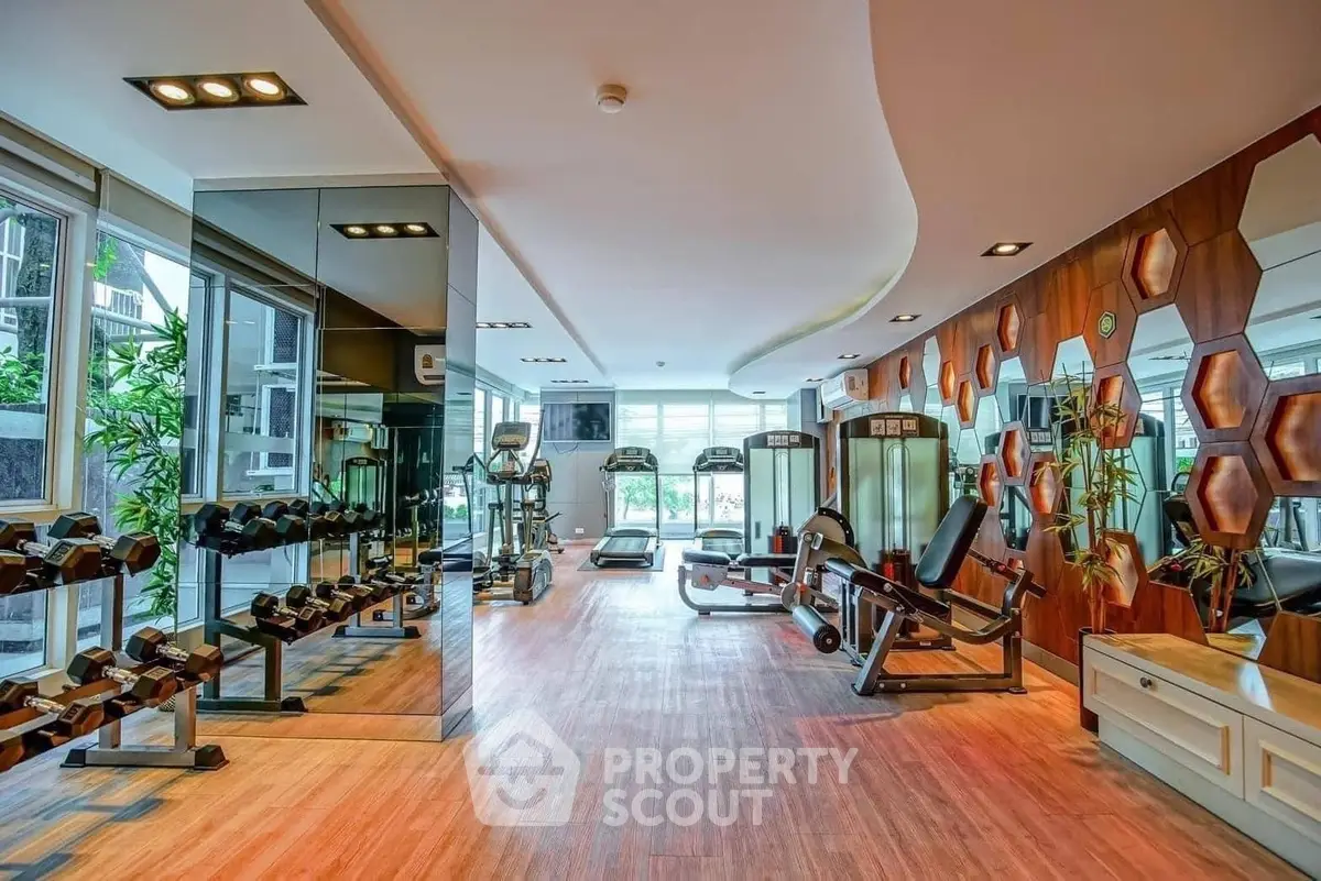 Luxurious gym with modern equipment and stylish design in upscale property