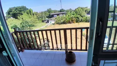 Charming balcony with scenic garden view and lush greenery