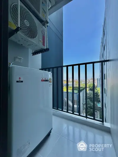 Modern apartment balcony with washing machine and city view