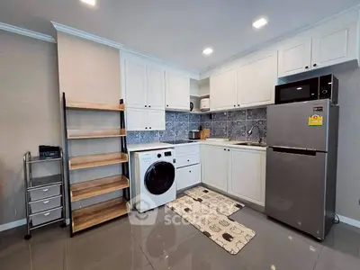 Modern kitchen with sleek appliances and stylish shelving in a contemporary apartment.