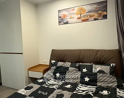 Cozy bedroom with modern decor and stylish bedding in a contemporary apartment.