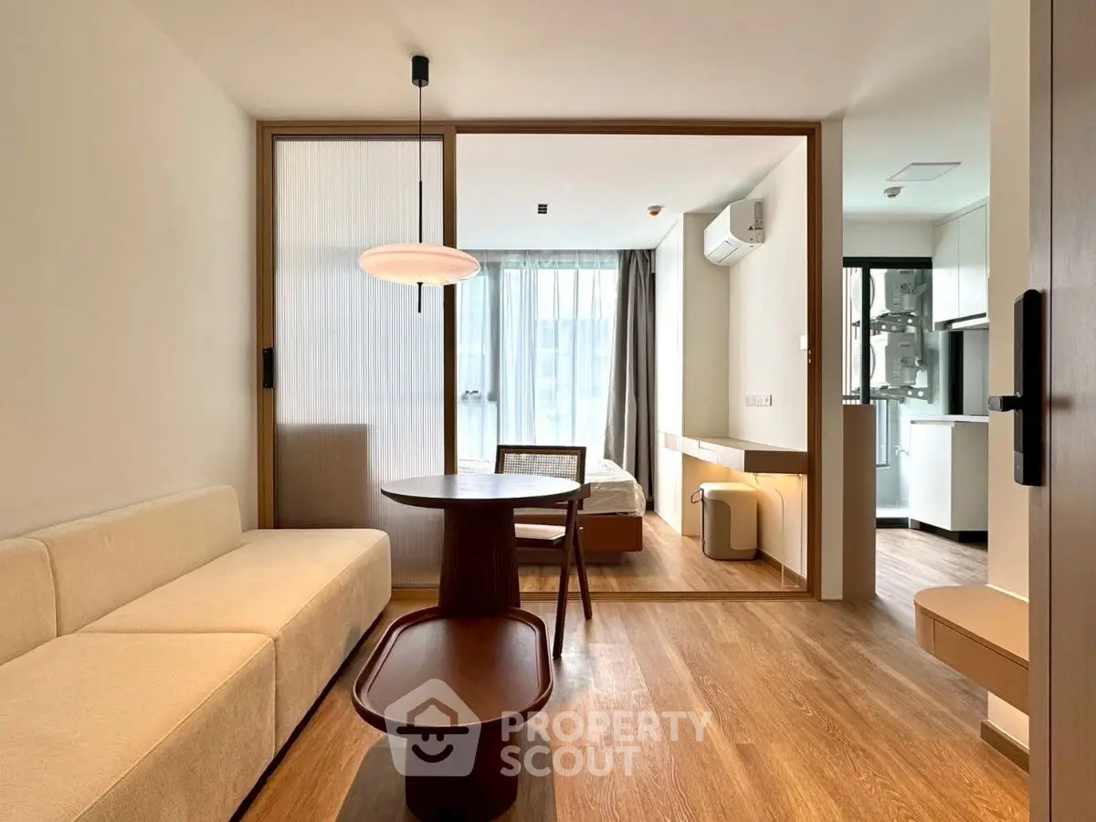 Modern open-plan living room with wooden floors and stylish furniture