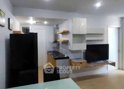 Modern open-layout kitchen with sleek cabinetry and integrated appliances