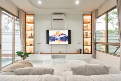 Modern living room with large windows, cozy sofa, and stylish built-in shelves.