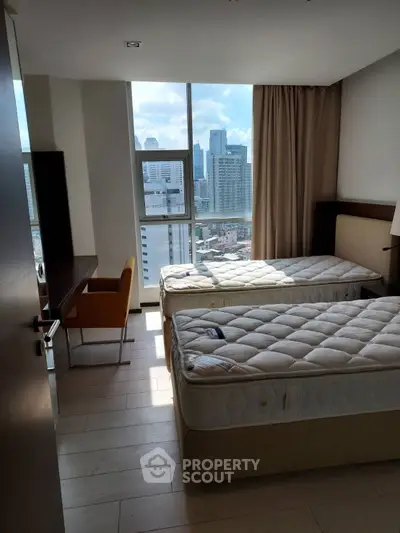 Modern bedroom with twin beds and city view, perfect for urban living.