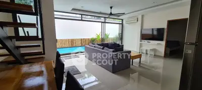 Modern living room with pool view, stylish furniture, and open layout design.