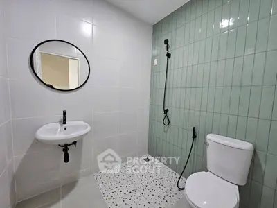 Modern bathroom with stylish green tiles and sleek fixtures