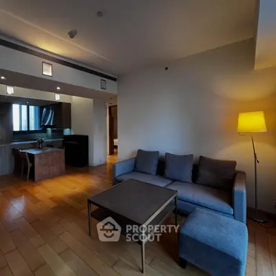 Spacious living room with modern open kitchen and cozy lighting