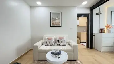 Modern living room with cozy sofa and stylish decor in a contemporary apartment.