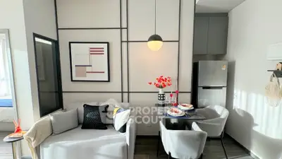 Modern living room with stylish decor and dining area, featuring contemporary furniture and wall art.