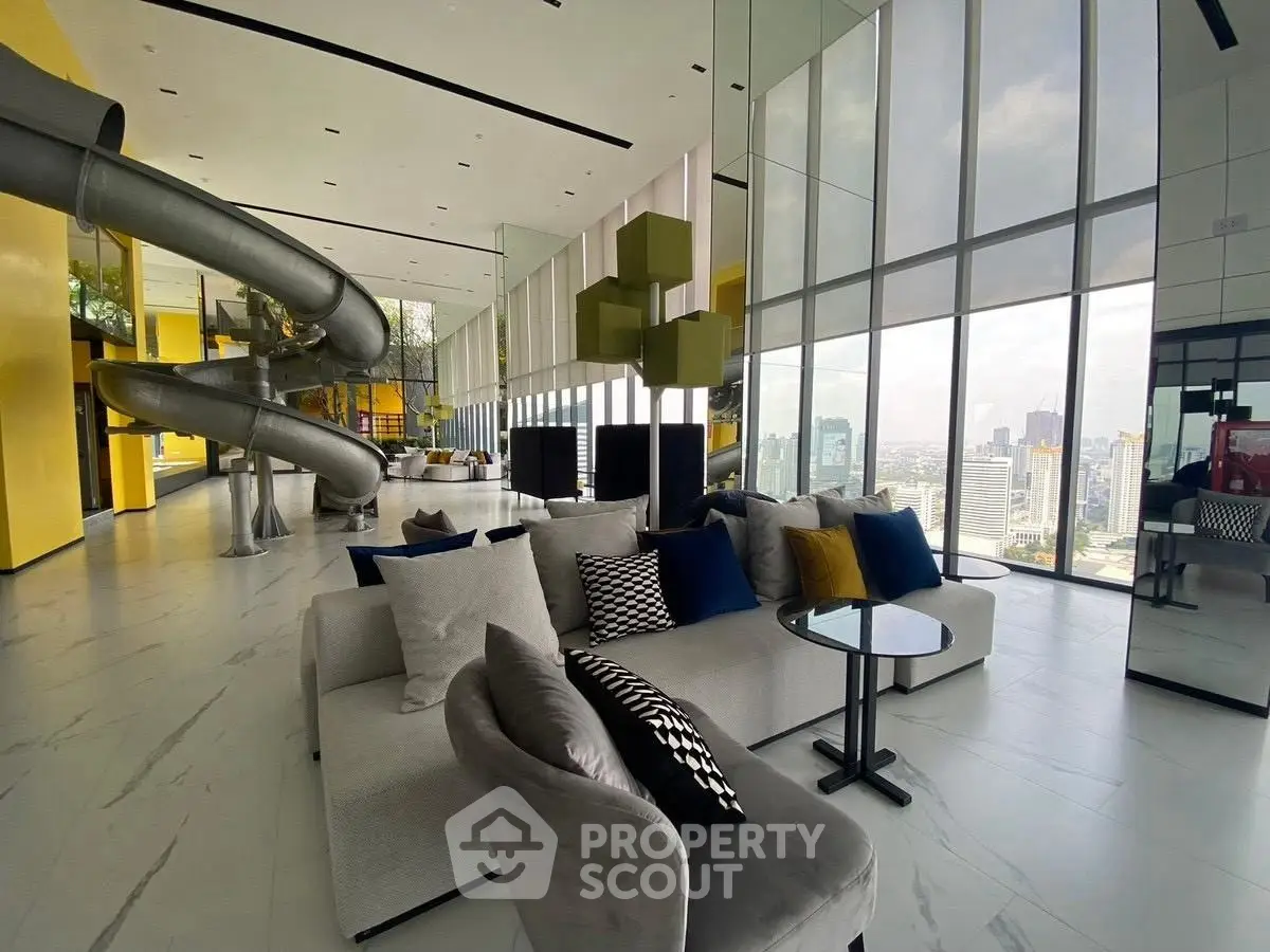Luxurious modern living room with panoramic city views and unique slide feature.
