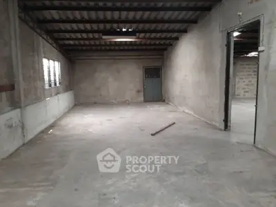Spacious industrial warehouse with concrete flooring and high ceiling
