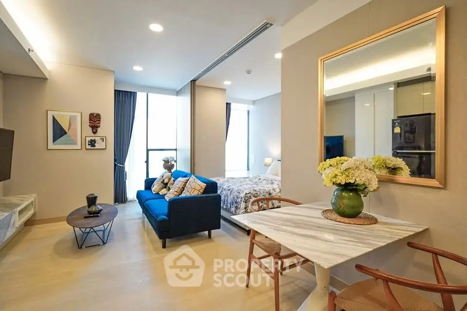 Modern open-plan living room with stylish decor and cozy seating area in a contemporary apartment.
