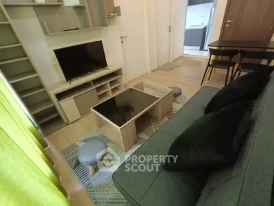 Modern living room with stylish furniture and open kitchen view, perfect for cozy urban living.
