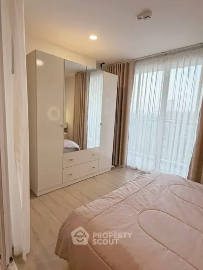 Bright and cozy bedroom with large windows and modern wardrobe