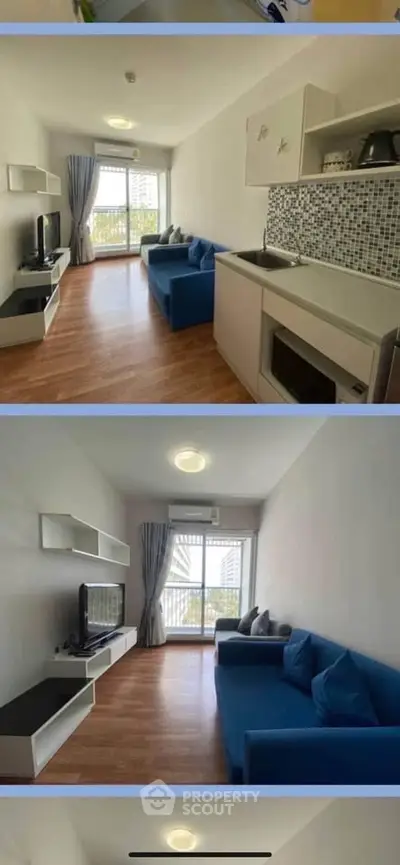 Modern living room with open kitchen, blue sofa, and large window with city view.