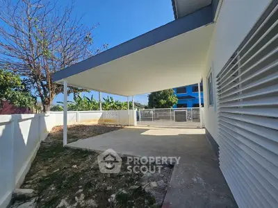 Spacious covered patio in modern home with sleek design and ample outdoor space.