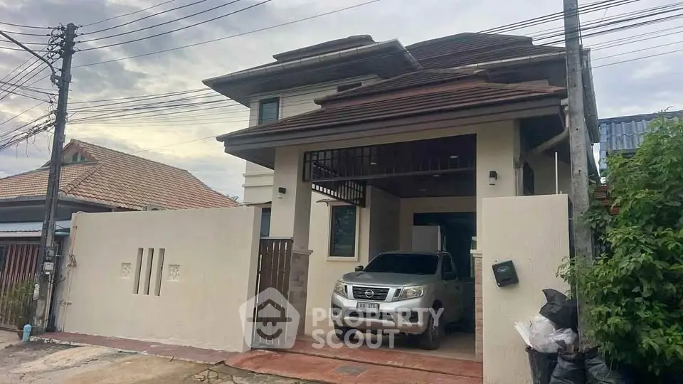 Charming two-story house with carport and modern design in a serene neighborhood.