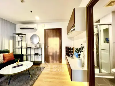 Modern living room with stylish decor and adjacent bathroom