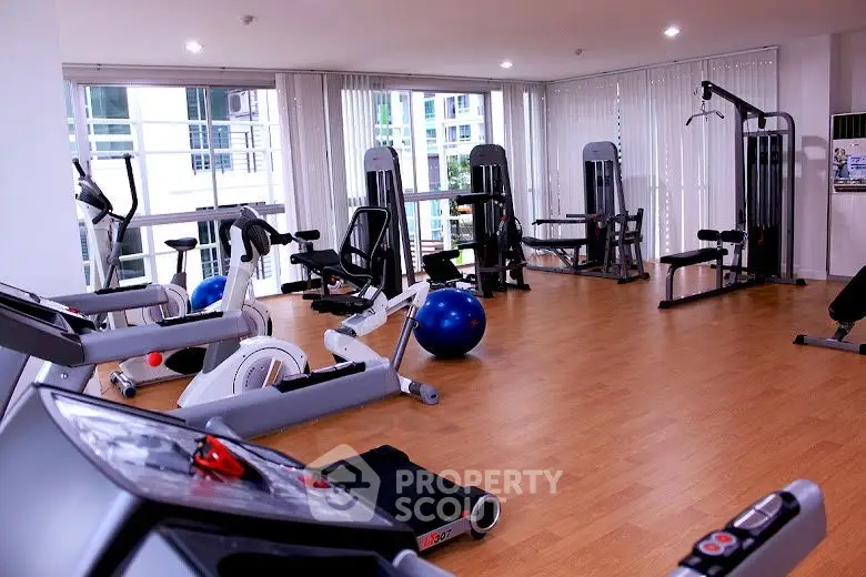 Modern gym with state-of-the-art fitness equipment and bright natural lighting.