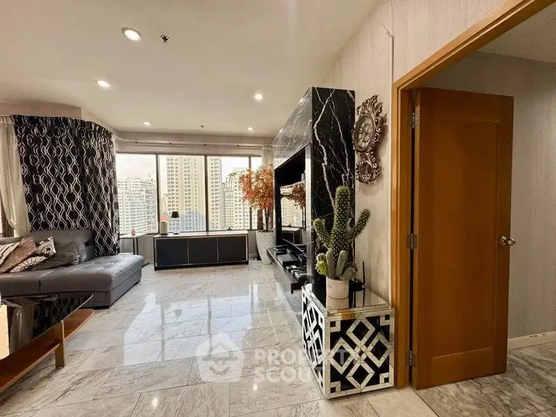Spacious living room with modern decor and city view, featuring marble flooring and stylish furnishings.