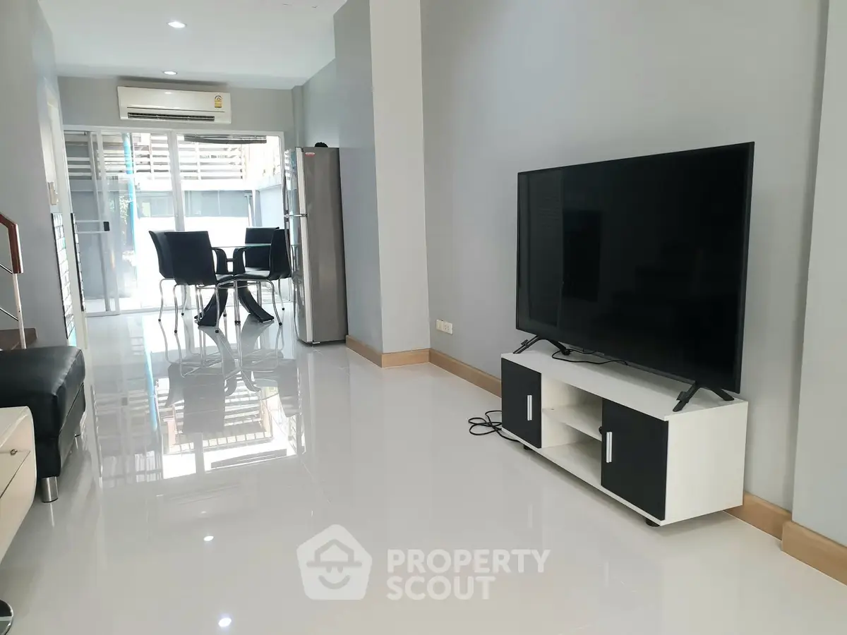 Spacious modern living room with sleek furniture and dining area